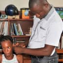 Staff in the Audiology Department support a child at St Joseph’s School for the Deaf, in Makeni, Sierra Leone