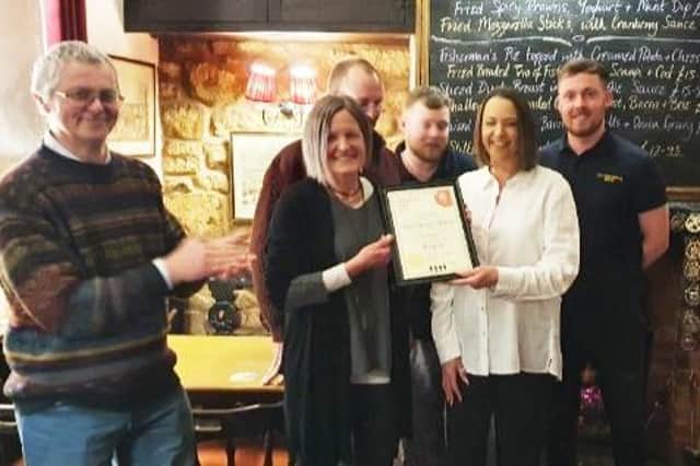 The Evans family at the Stilton Cheese pub, at Somerby, are presented with their CAMRA award