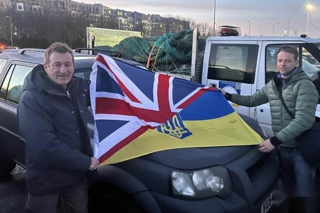 Iain Terpening (left) with a flag showing the bond between the UK and Ukraine
