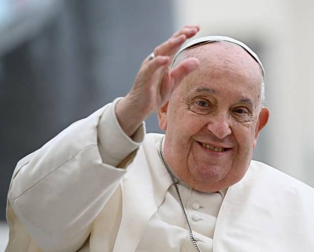 Pope Francis waves to the crowd during the weekly general audience at St Peter's Square in The Vatican on November 20, 2024.  (Photo by Filippo MONTEFORTE / AFP) (Photo by FILIPPO MONTEFORTE/AFP via Getty Images)
