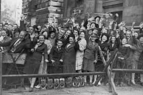 Crowds at Downing Street, London, cheer prime minister Clement Attlee after the surrender of Japan in August 1945.    (Photo by Keystone/Getty Images)