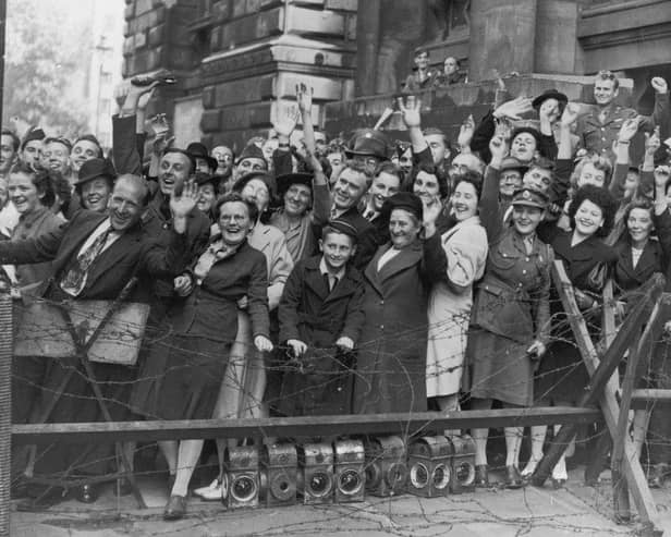 Crowds at Downing Street, London, cheer prime minister Clement Attlee after the surrender of Japan in August 1945.    (Photo by Keystone/Getty Images)