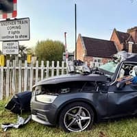 Woman escapes with minor injuries after car hit by freight train