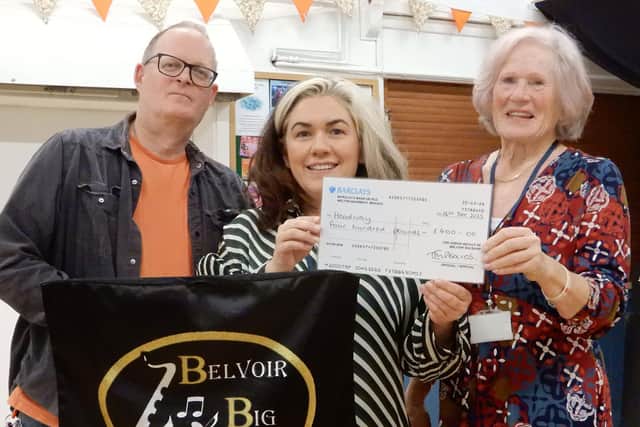 From left, Allan Toombs (Belvoir Big Band) presents a cheque to Headway's Rhiana Lakin and Vicky Davison