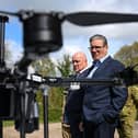 Prime Minister Keir Starmer (R) and New Zealand's Prime Minister Christopher Luxon (2R) look at SYOS Aerospace drones and UAVs during a visit a British army base in the west of England, in April  (Photo by FINNBARR WEBSTER/POOL/AFP via Getty Images)