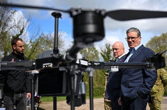 Prime Minister Keir Starmer (R) and New Zealand's Prime Minister Christopher Luxon (2R) look at SYOS Aerospace drones and UAVs during a visit a British army base in the west of England, in April (Photo by FINNBARR WEBSTER/POOL/AFP via Getty Images)
