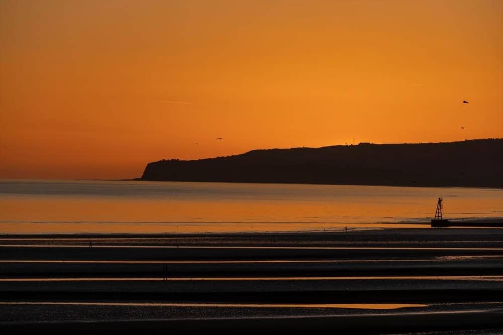 The sun sets over Camber Sands.