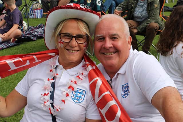 A couple cheer on England on the big screen in Play Close Park