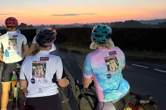 Some of the cyclist pause to enjoy a stunning pink sky en route to Norfolk