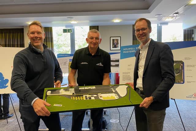 Project leader, Chris Williams, with two Saint Gobain colleagues, holding a model of the planned new factory