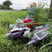 Floral tributes left by the side of Melton Spinney Road, near Scalford, after the death of cyclist