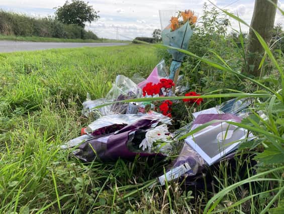 Floral tributes left by the side of Melton Spinney Road, near Scalford, after the death of cyclist