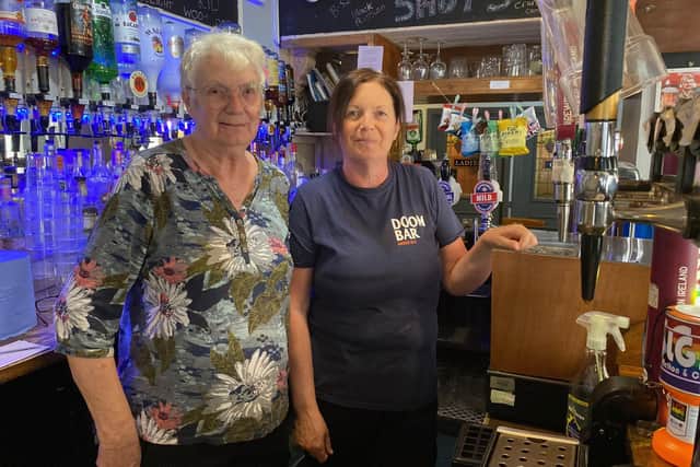 Sharon Brown and her mum June behind the bar at The Grapes as the family prepares to leave after 16 years