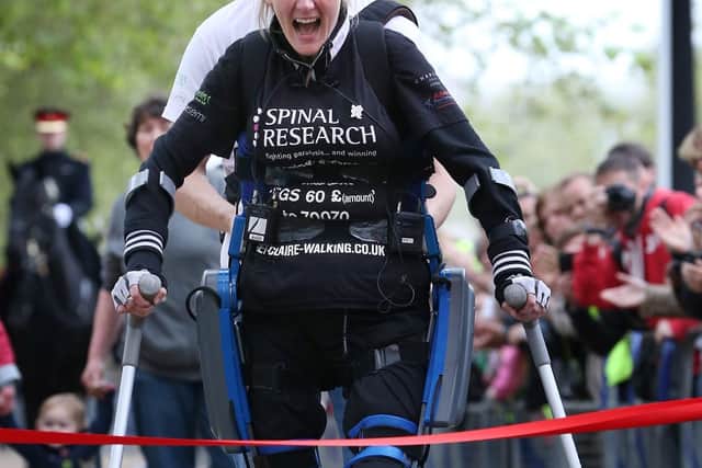 LONDON, ENGLAND - MAY 08:  Claire Lomas crosses the finishing line of the Virgin London Marathon on May 8, 2012 in London, England. Ms Lomas, who is paralysed from the waist down after a riding accident in 2007, has taken 16 days to complete the 26.2 mile route. Starting out with 36,000 other runners she has averaged 2 miles a day with the help of a bionic ReWalk suit.  (Photo by Peter Macdiarmid/Getty Images)