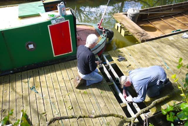 Melton and Oakham Waterways Society volunteers work on the landing stage ahead of boats being hired this summer