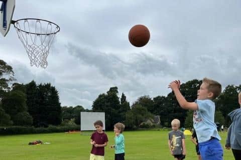 Shooting at a basketball hoop during a Belvoir Education & Sports Trust summer scheme in the Vale