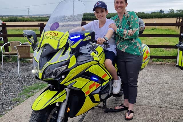 Charlie with mum, Melina, with one of the motorbikes used by members of Leicestershire and Rutland Blood Bikes group