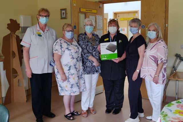 Inner wheel members present a DVD player to staff at Melton Hospital
