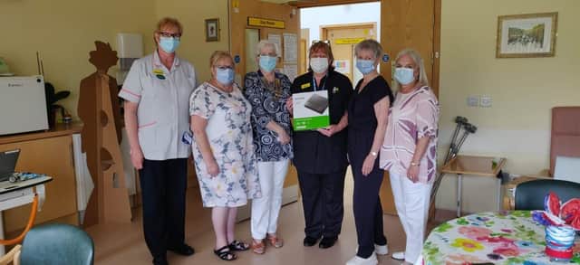 Inner wheel members present a DVD player to staff at Melton Hospital