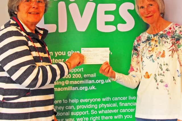 Dr. Liz Pearce, (left) Belvoir Big Band treasurer, presenting a cheque for £1.600 to Janet Gilchrist (right) the secretary of the Melton branch of the Macmillan Cancer Support fundraisers following a charity concert