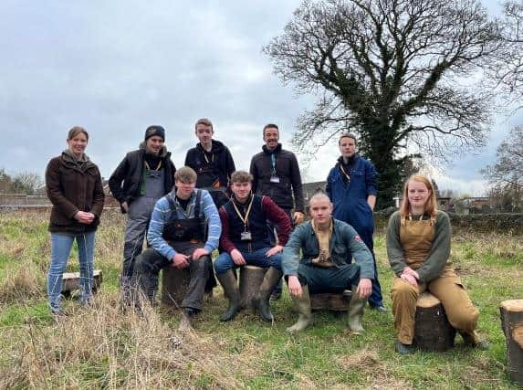 Brooksby students with the tree stump seats they made for Rearsby schoolchildren