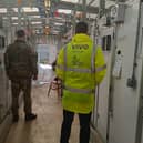 Army personnel and VIVO member of staff inside the kennels at Melton's DATR HQ where a new heating system has been installed