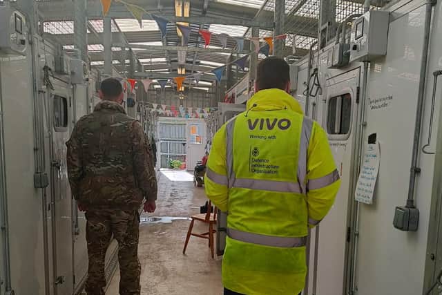 Army personnel and VIVO member of staff inside the kennels at Melton's DATR HQ where a new heating system has been installed