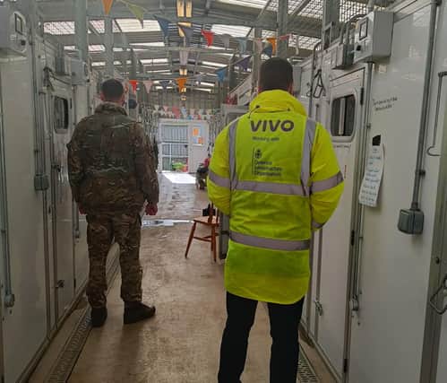 Army personnel and VIVO member of staff inside the kennels at Melton's DATR HQ where a new heating system has been installed