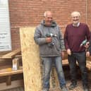 Melton Mowbray Lions Club members install a new 'friendly bench' in the Bell Centre