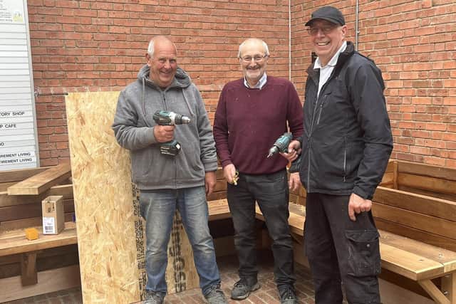 Melton Mowbray Lions Club members install a new 'friendly bench' in the Bell Centre