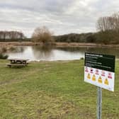 Melton Country Park's lake with one of the new safety signs