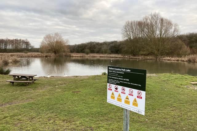 Melton Country Park's lake with one of the new safety signs
