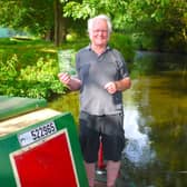 Melton and Oakham Waterways Society committee member, Dave Andow, with a copy of The Melton Mowbray Navigation on the Society’s narrowboat, which will be operating trips on the waterway from early spring.