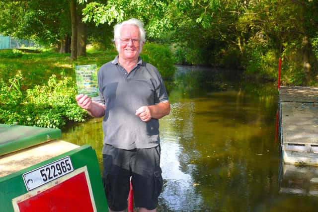 Melton and Oakham Waterways Society committee member, Dave Andow, with a copy of The Melton Mowbray Navigation on the Society’s narrowboat, which will be operating trips on the waterway from early spring.