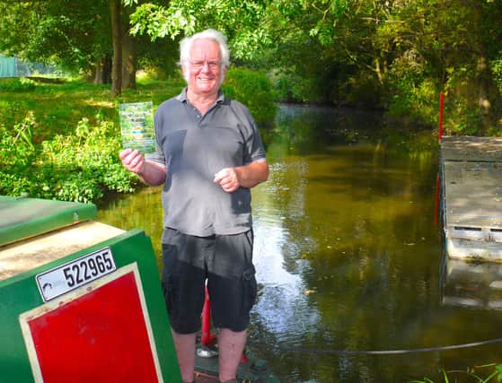 Melton and Oakham Waterways Society committee member, Dave Andow, with a copy of The Melton Mowbray Navigation on the Society’s narrowboat, which will be operating trips on the waterway from early spring.