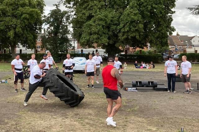 Scott Lansdowne, the overall winner of the first Power in the Park event, takes part in the tyre flipping race against the clock