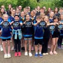 Melton Mowbray Swimming Club members with their 60th anniversary caps.