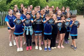 Melton Mowbray Swimming Club members with their 60th anniversary caps.