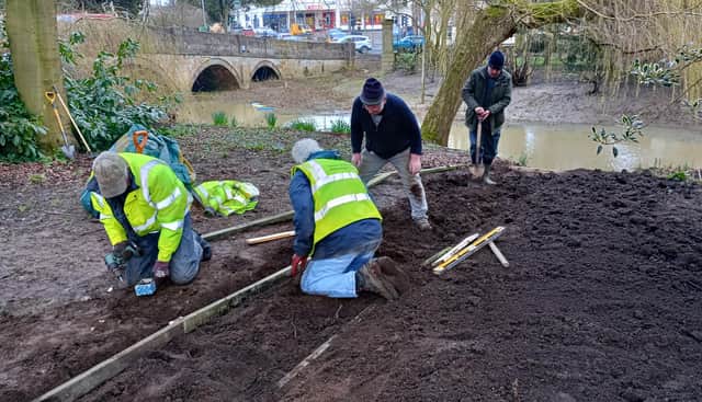 MOWS volunteers lay the path to the River Eye at the new rowing boat hire base in Wilton Park, Melton
