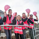 The site team at Barratt Homes' King’s Meadow, off Kirby Lane, Melton, dressed in bright pink hats and vests for the Breast Cancer Now 'Wear it pink' campaign