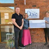A cheque is presented to Dove Cottage Day Hospice from the Velo Belvoir event