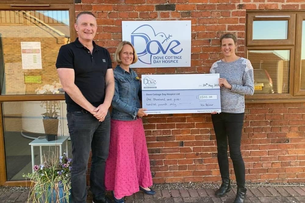 A cheque is presented to Dove Cottage Day Hospice from the Velo Belvoir event
