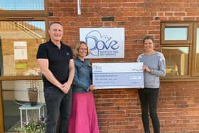 A cheque is presented to Dove Cottage Day Hospice from the Velo Belvoir event