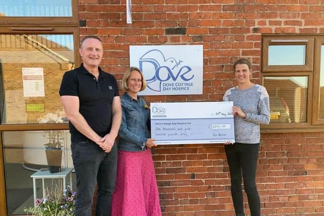 A cheque is presented to Dove Cottage Day Hospice from the Velo Belvoir event
