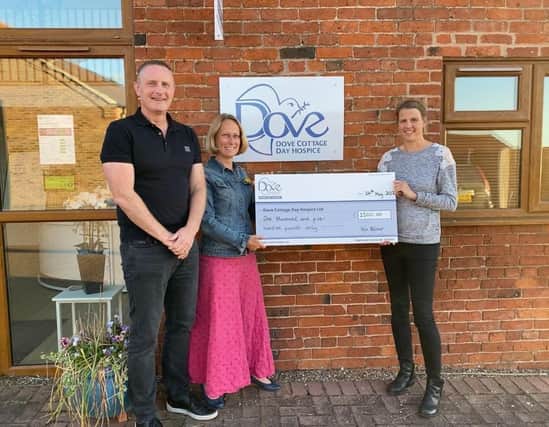 A cheque is presented to Dove Cottage Day Hospice from the Velo Belvoir event