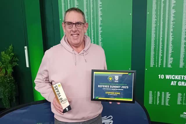Stephen King with his award for completing 50 years as a football referee