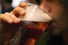 Picture of someone drinking a pint of beer. Pic: PA