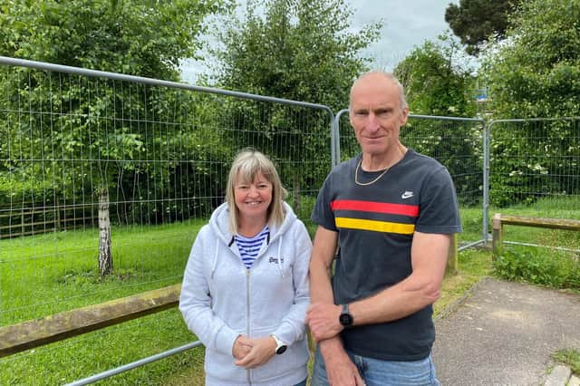 Paul and Debbie Biggadyke beside the now fenced off area of green space so precious to fellow residents of Navigation Close in Melton