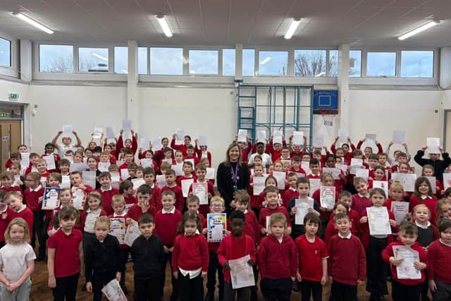 Headteacher Natalie Willcock with pupils at Asfordby Captain's Close Primary School holding letters they've sent to Loughborough College Group