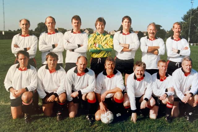 Baz Cousins (hand on football) with team mates for a match at Egerton Park